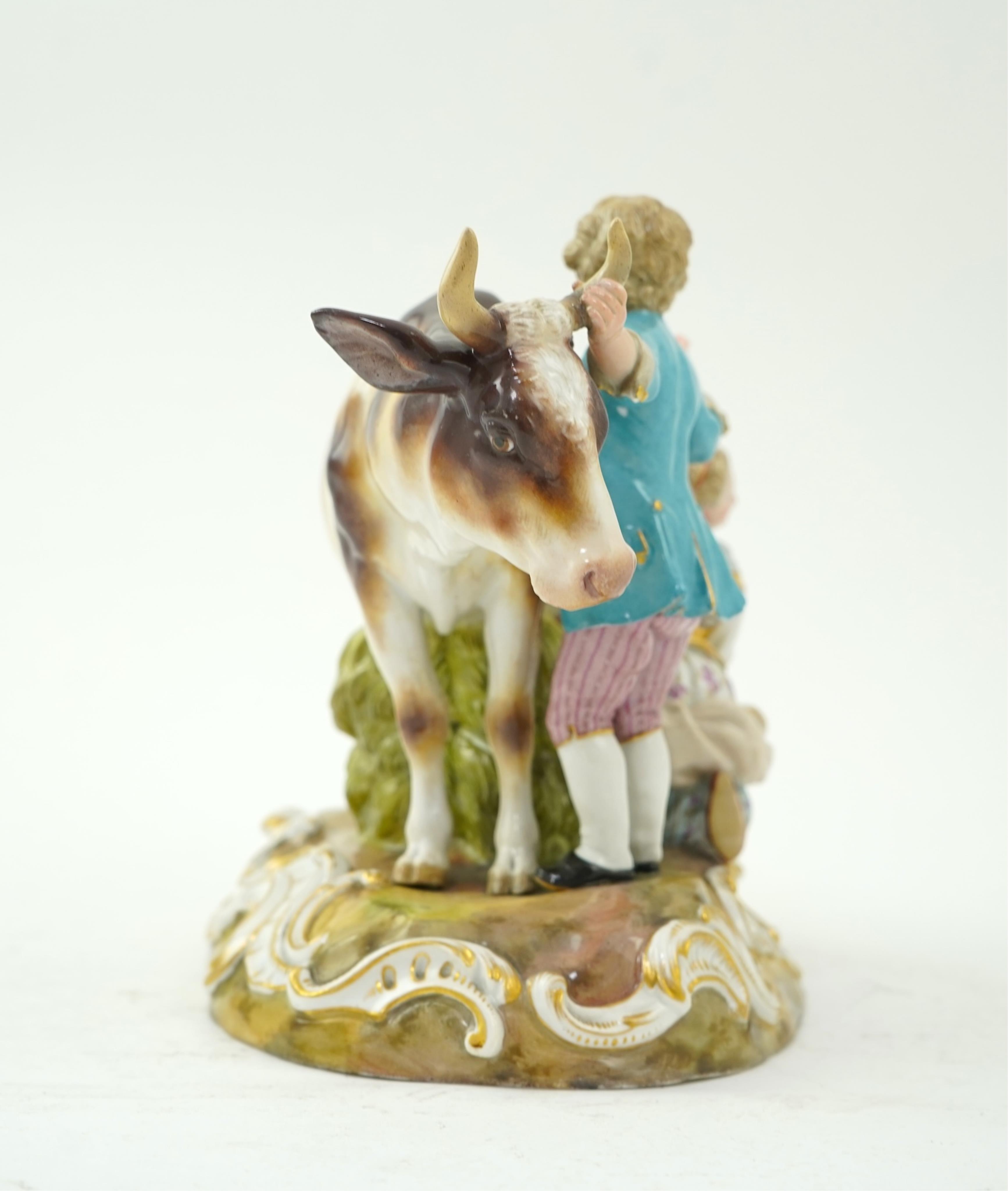 A Meissen group of a boy and girl milking a cow, 19th century